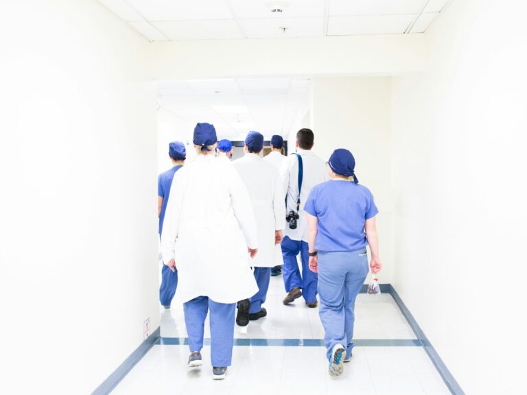 Team of healthcare professionals walking through a hospital hallway